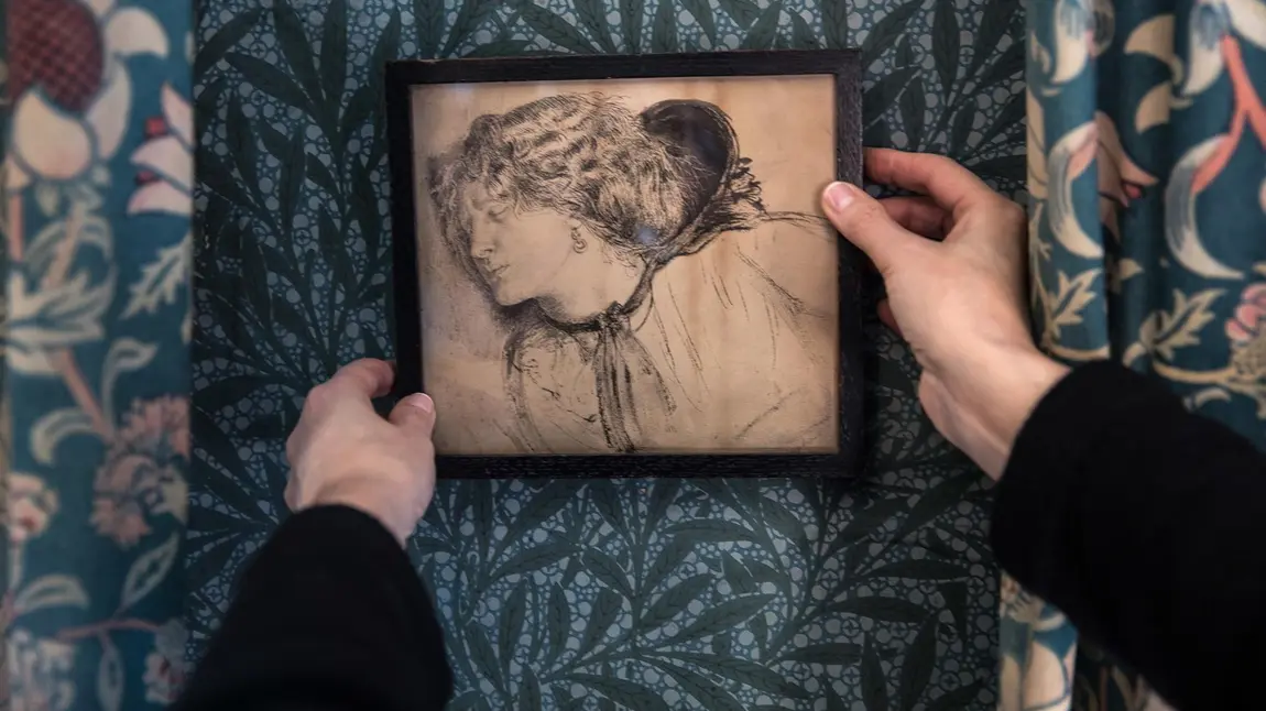 Two hands holding a drawing