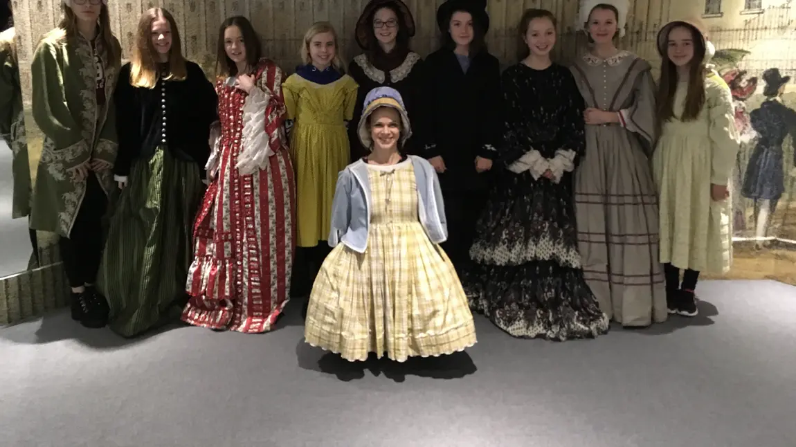 Young people trying on costumes at Bath Costume Museum