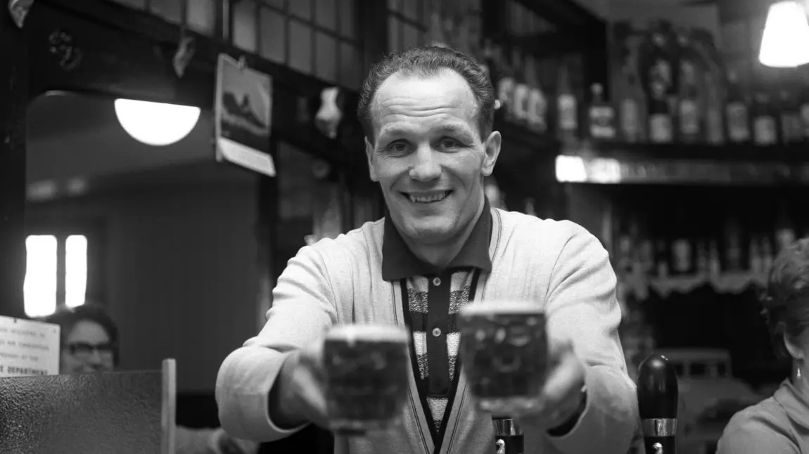 Henry Cooper behind the bar of The Fellowship Inn, South London in 1963