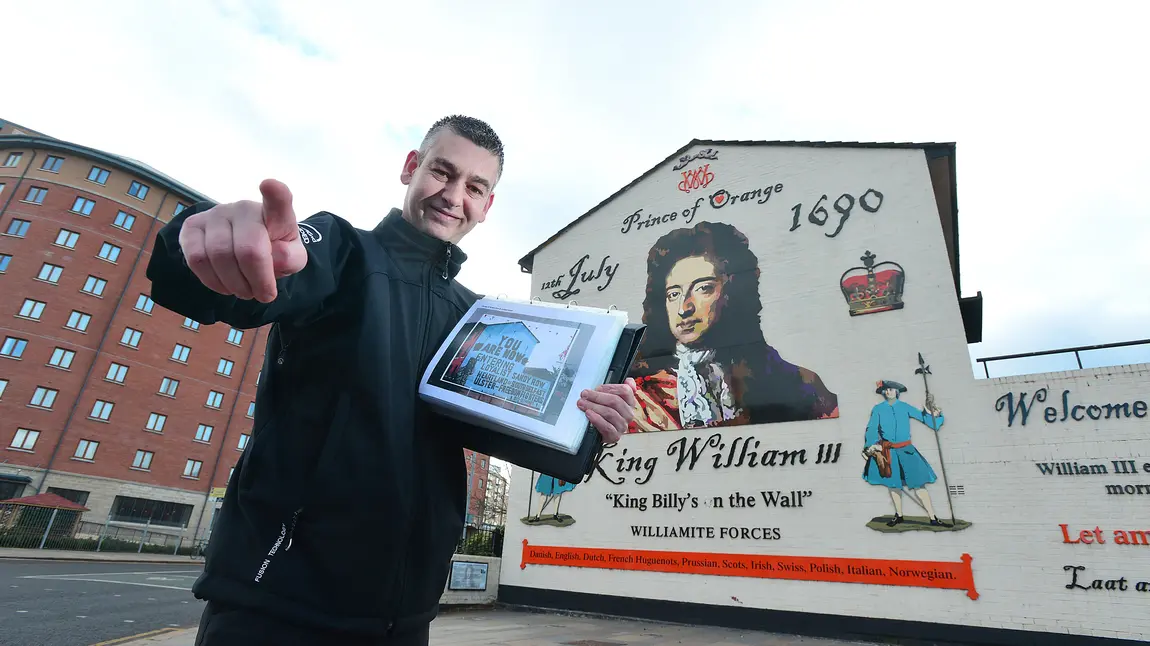 Tour guide Paul McCann at a mural in Belfast Tour guide Paul McCann at a mural in Belfast