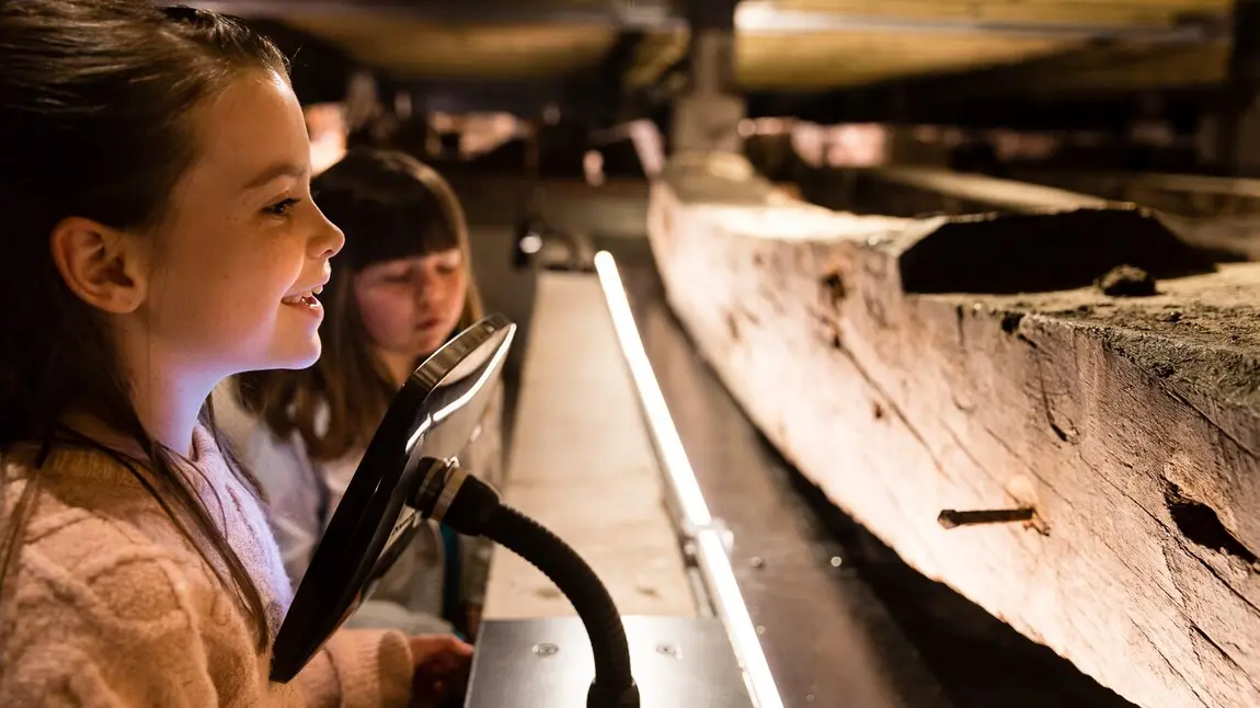 Children look at the remains of the Namur warship