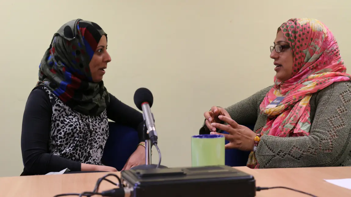 Women's memories were recorded, many for the first time Two women chat in front of a microphone
