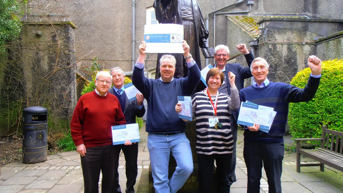 Staff and volunteers from the New Room celebrate the grant success