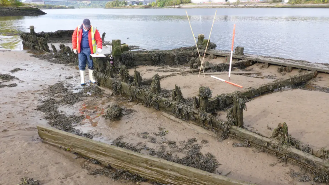 HLF supports plans to record UK's coastal archaeology A volunteer surveys the wreckage of a boat