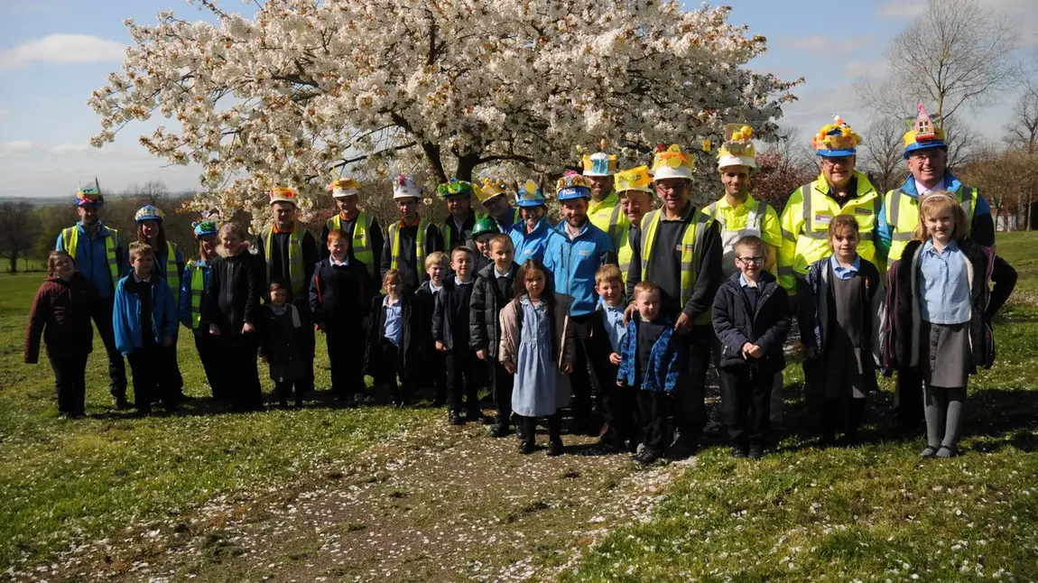 Bonnets and hard hats at Bolsover New Model Village Primary school children meet construction workers and apprentices at New Bolsover Model Village