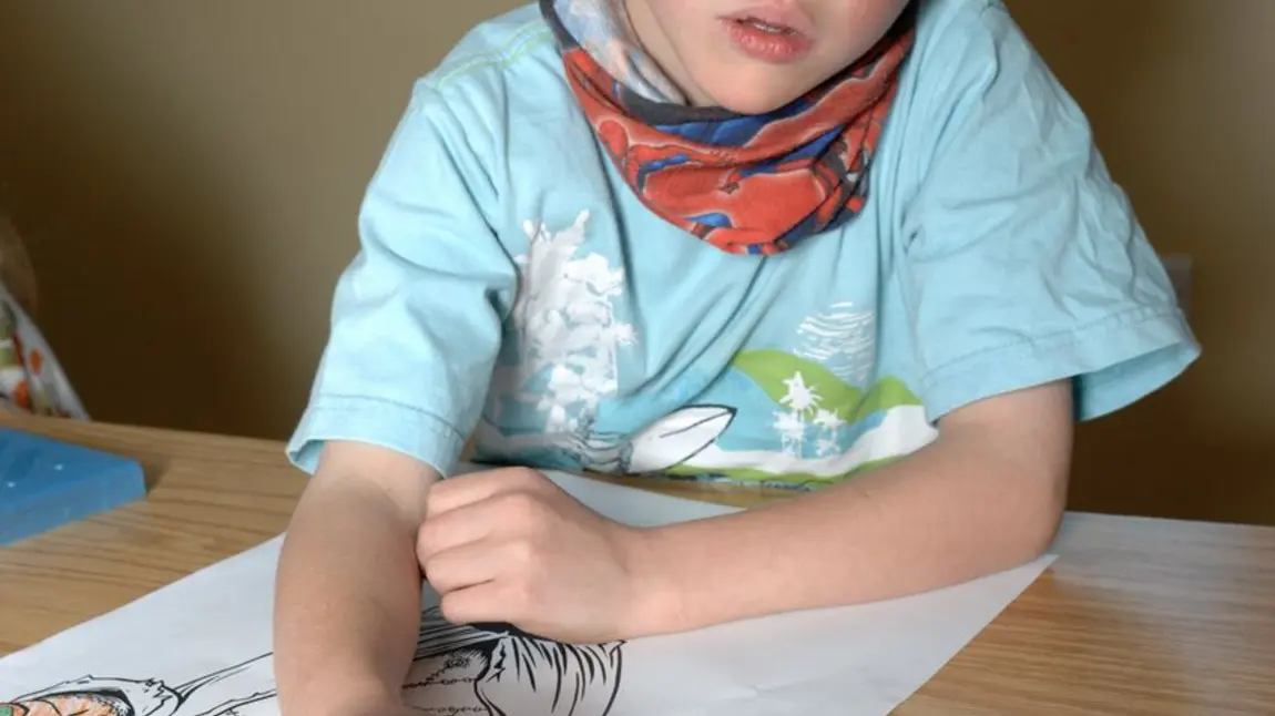A young boy drawing at Dove Cottage 