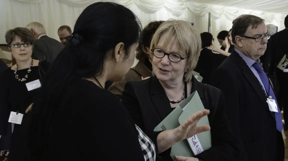 Dame Seona Reid talks to a woman at an event