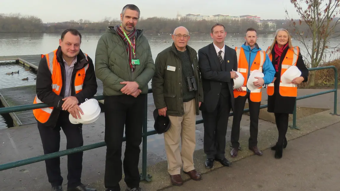 People stand in front of river