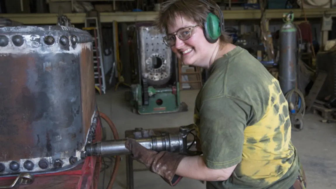 A woman fixes a steam engine