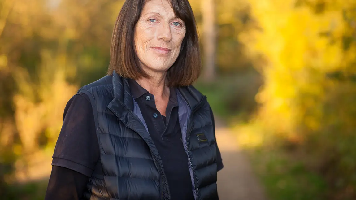 Changing lives: from hostage rescue to nature reserve A woman stands in front of autumn trees