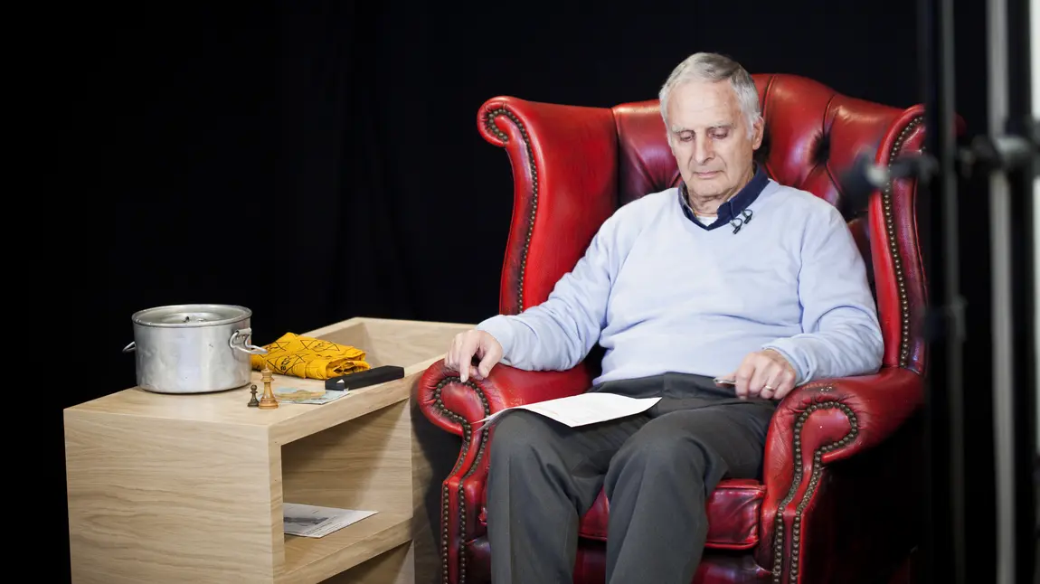 Steven prepares to be filmed on the Forever project Steven, sitting in a chair, reads notes and prepares to be filmed on the Forever project