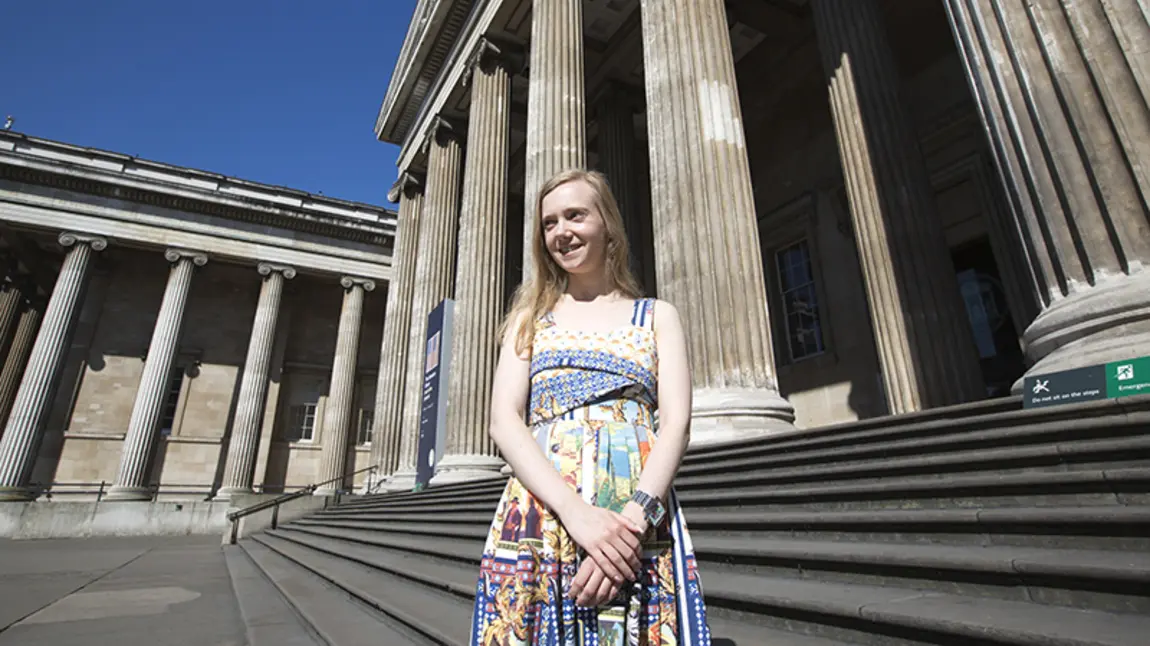 Jessica Starns stands outside the grand British Museum building, smiling