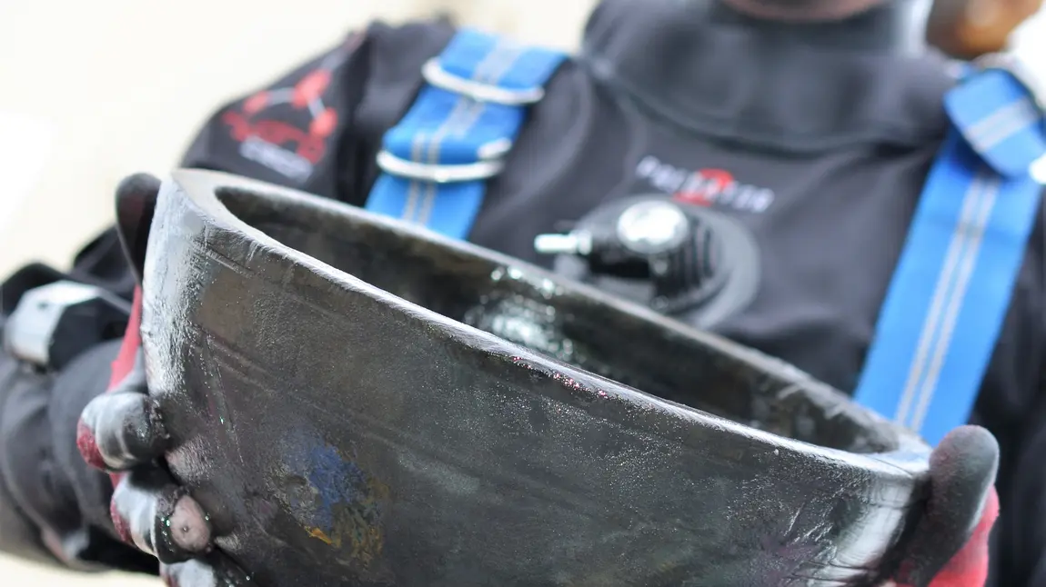 Senior archeaologist Giles Richardson with a bowl retrieved from HMS Invincible