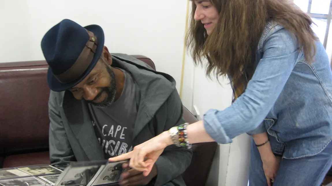 Lenny Henry and Emily Phillips looking through the Archival collection