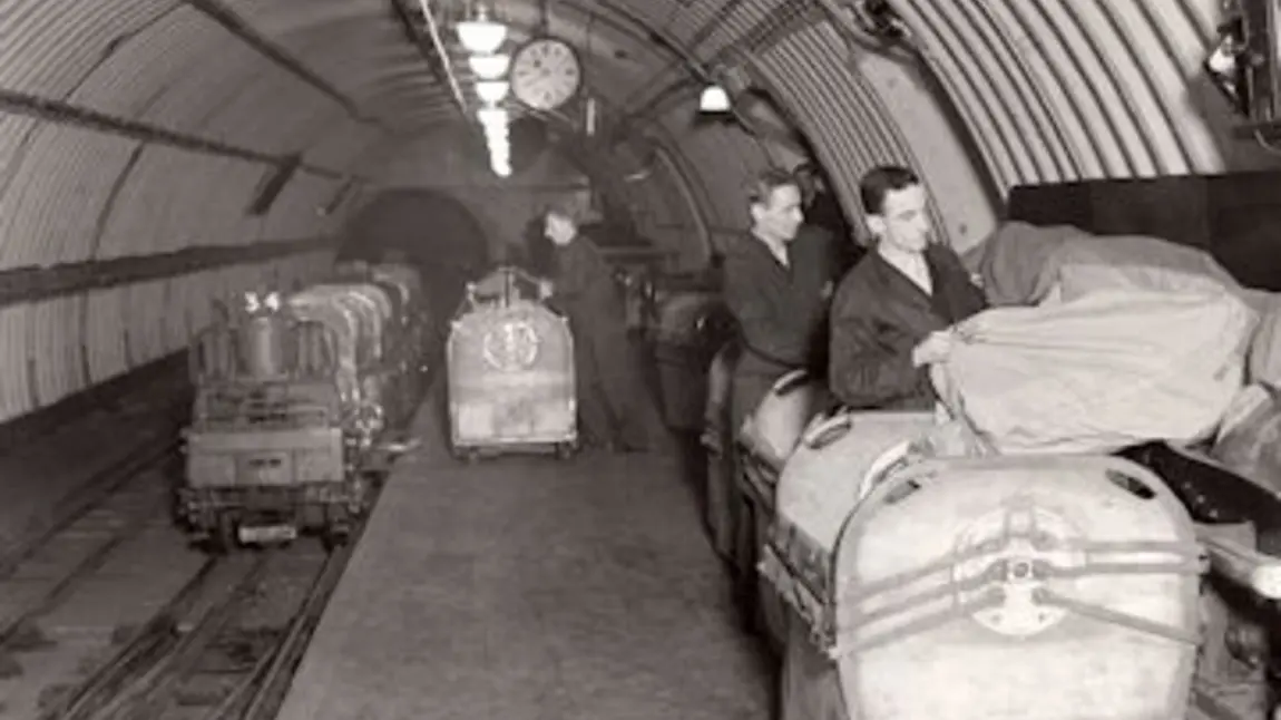 People sort post on the subterranean Mail Rail train