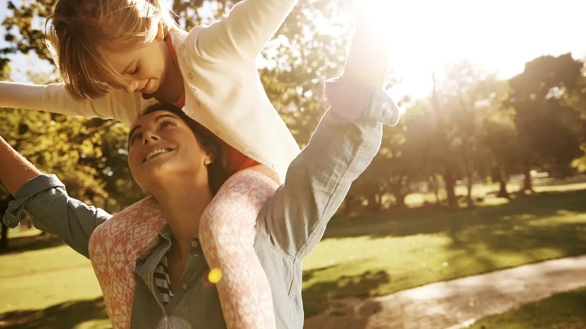 A mother and child have fun in a park