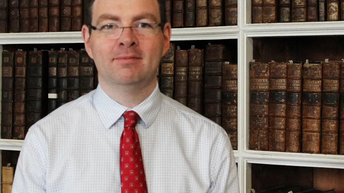 A man standing in a library