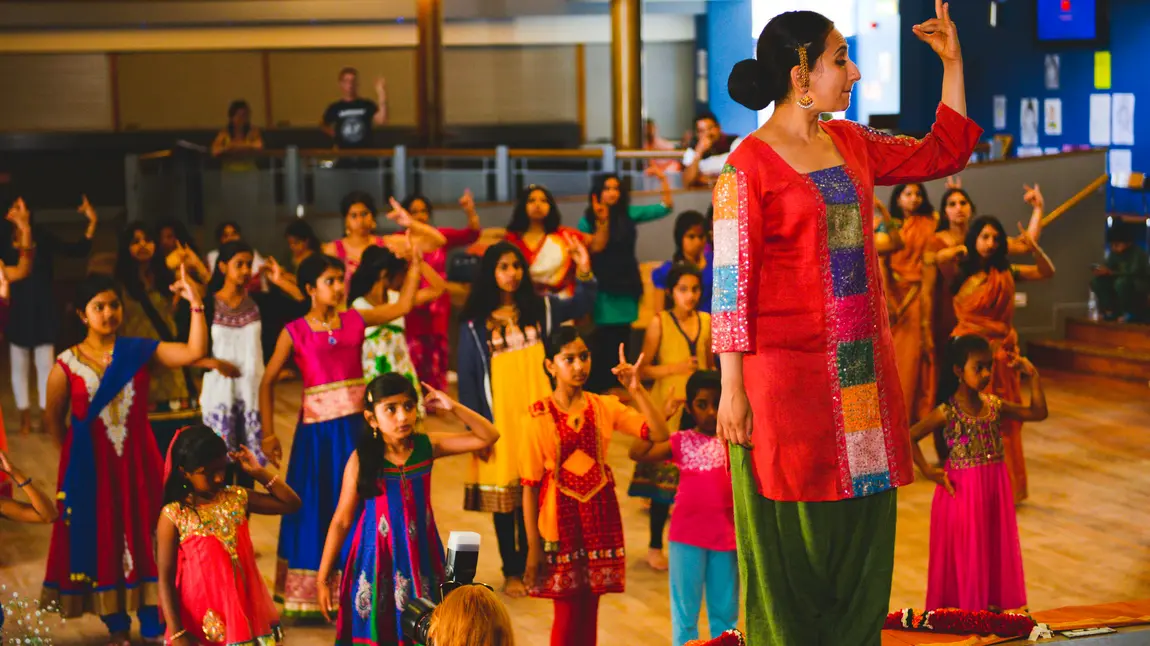 Children learn a South Asian dance 