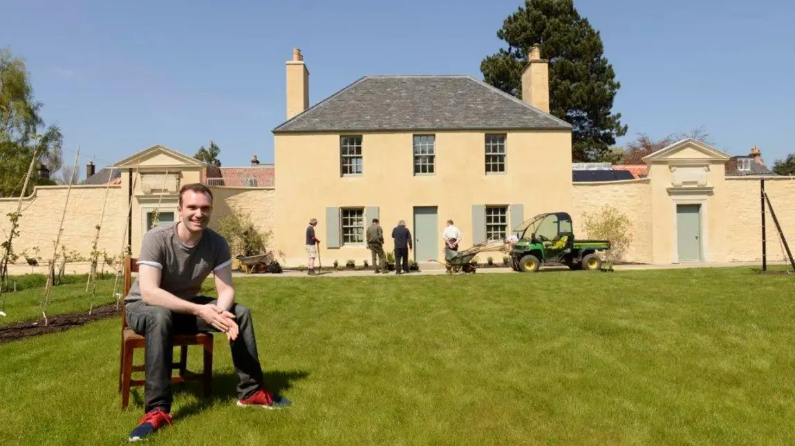 Sutherland Forsyth sitting in front of the Cottage