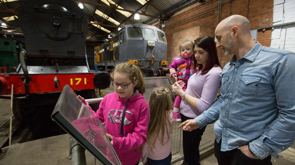A family enjoys one of the exhibits at the Railway Museum