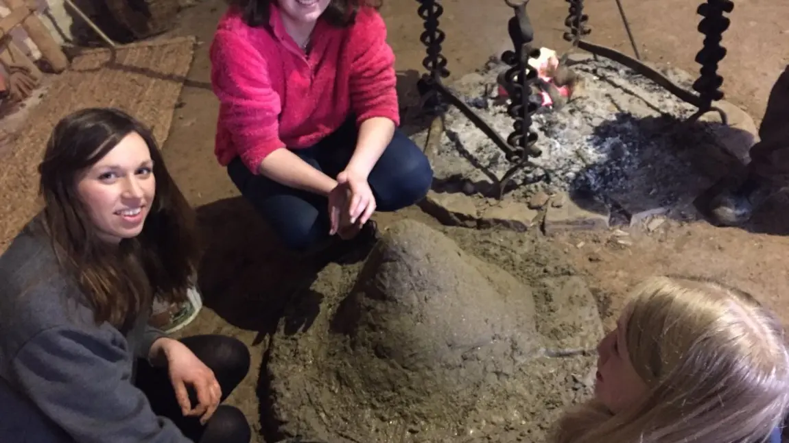 Young women with an Iron Age bread oven