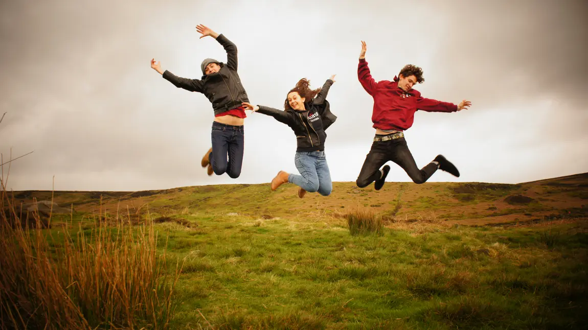 Young people jumping in a field