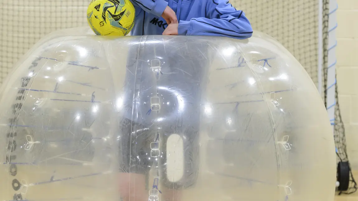 Danielle Pointon in a zorb with a football