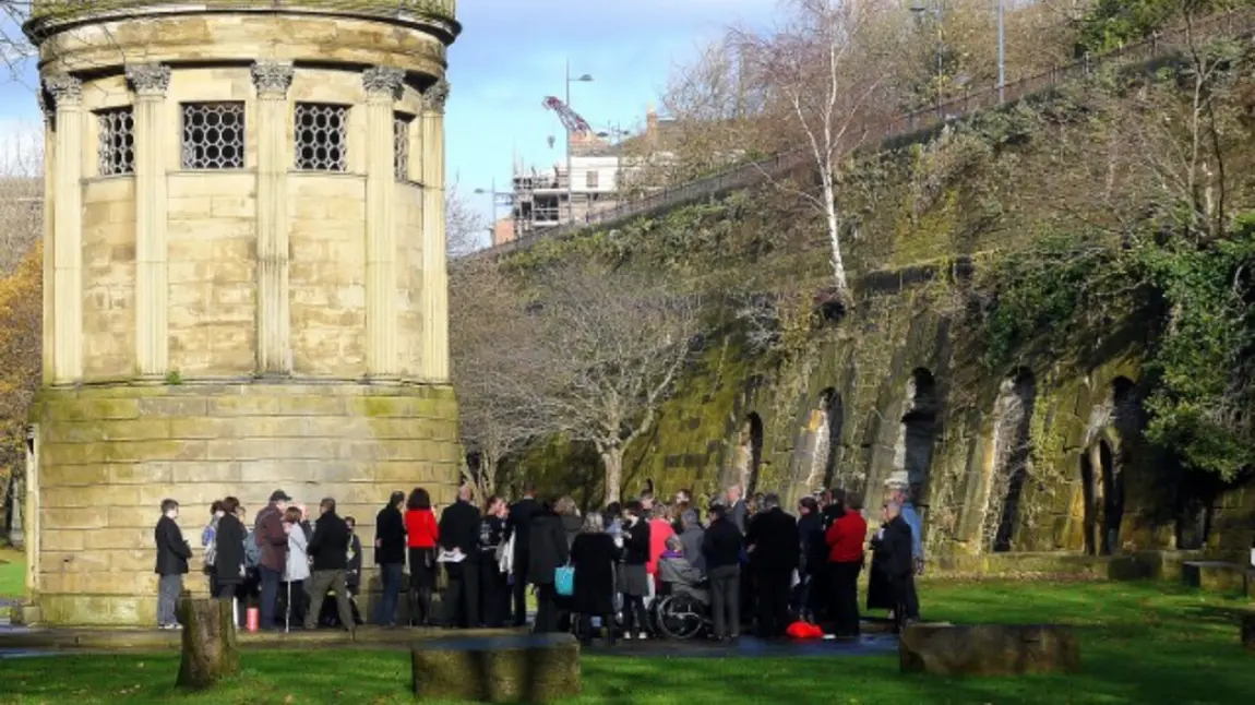 A group of people gathered in a graveyard