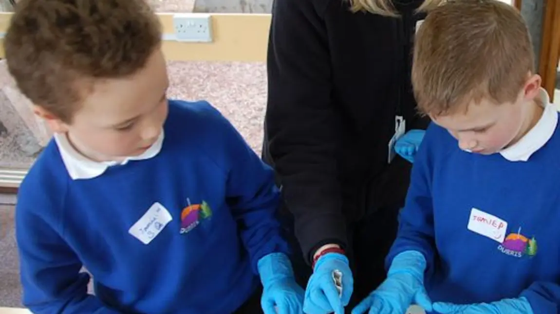 A teacher and pupils getting 'hands on' at Duthie Park 