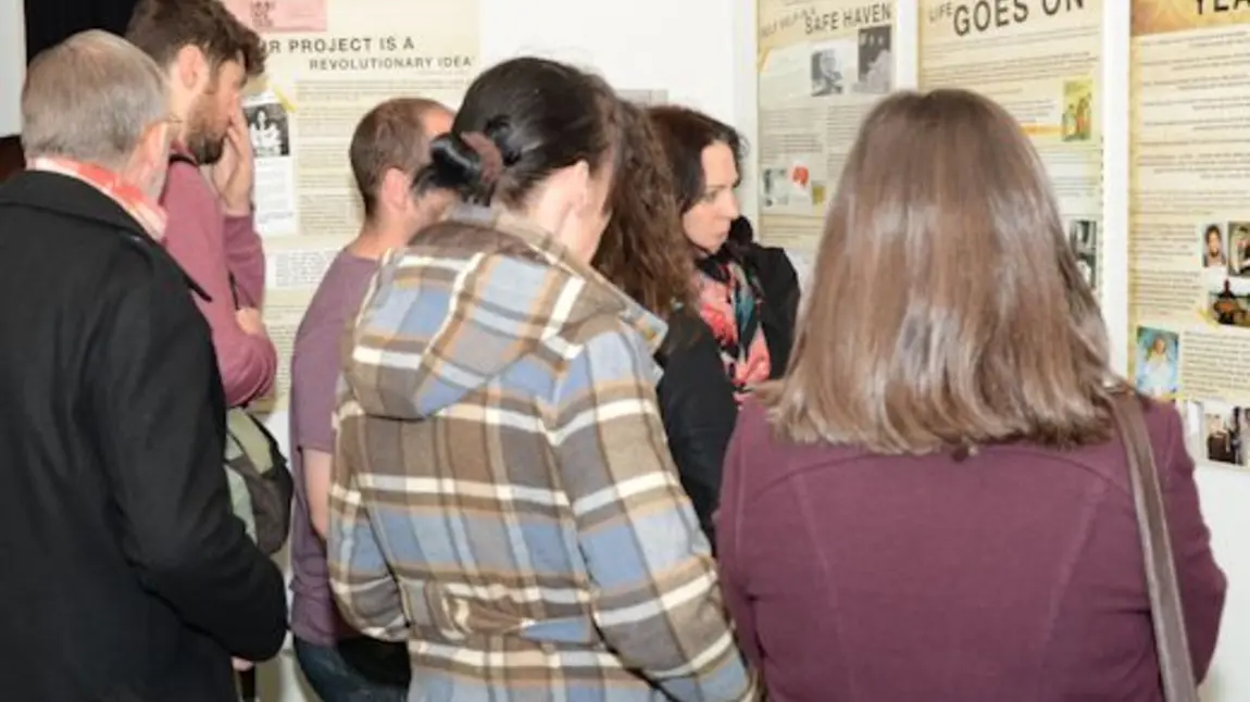 People visiting a Children of the Croft pop-up exhibition