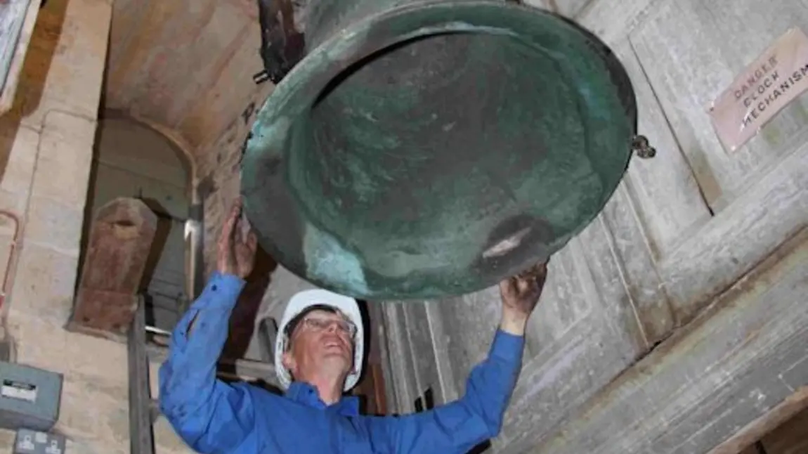 A volunteer restoring one of the bells at St Rumbald’s, Stoke Doyle 