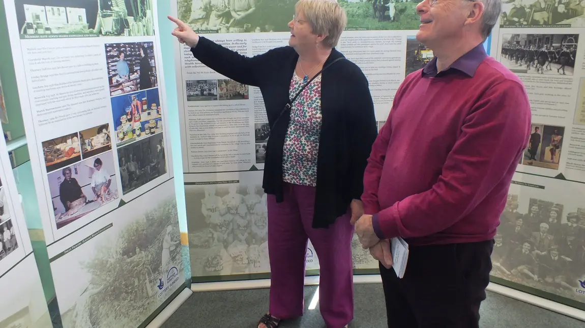 Two people look at the travelling exhibition at Ely Library