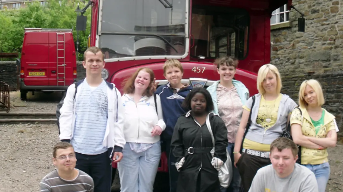 Young people in front of a vintage bus
