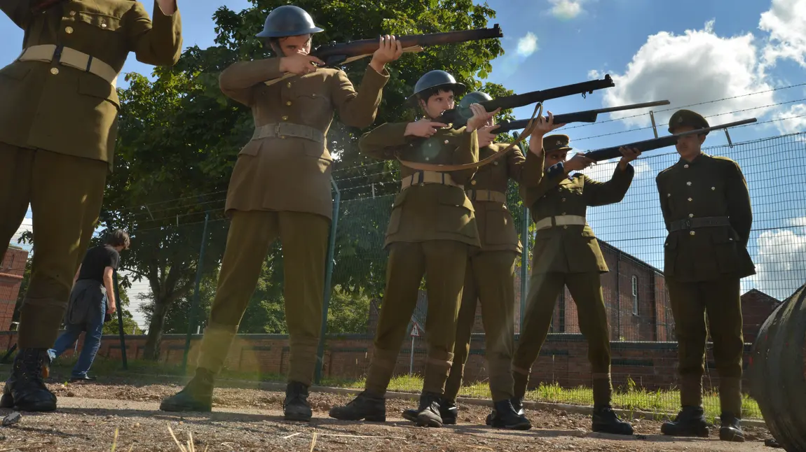 Men line up with guns to execute a soldier for cowardice. A still from ‘After Dawn’, the film created by young people at Central Youth Theatre.