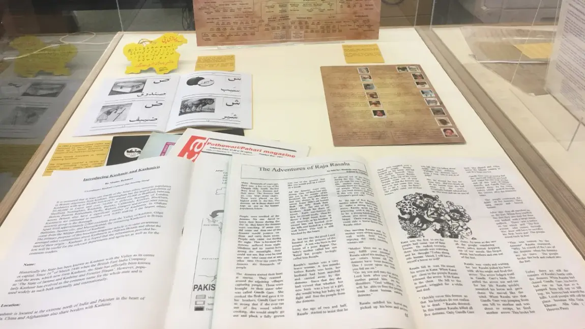 Booklets displayed in a glass display case at an exhibition