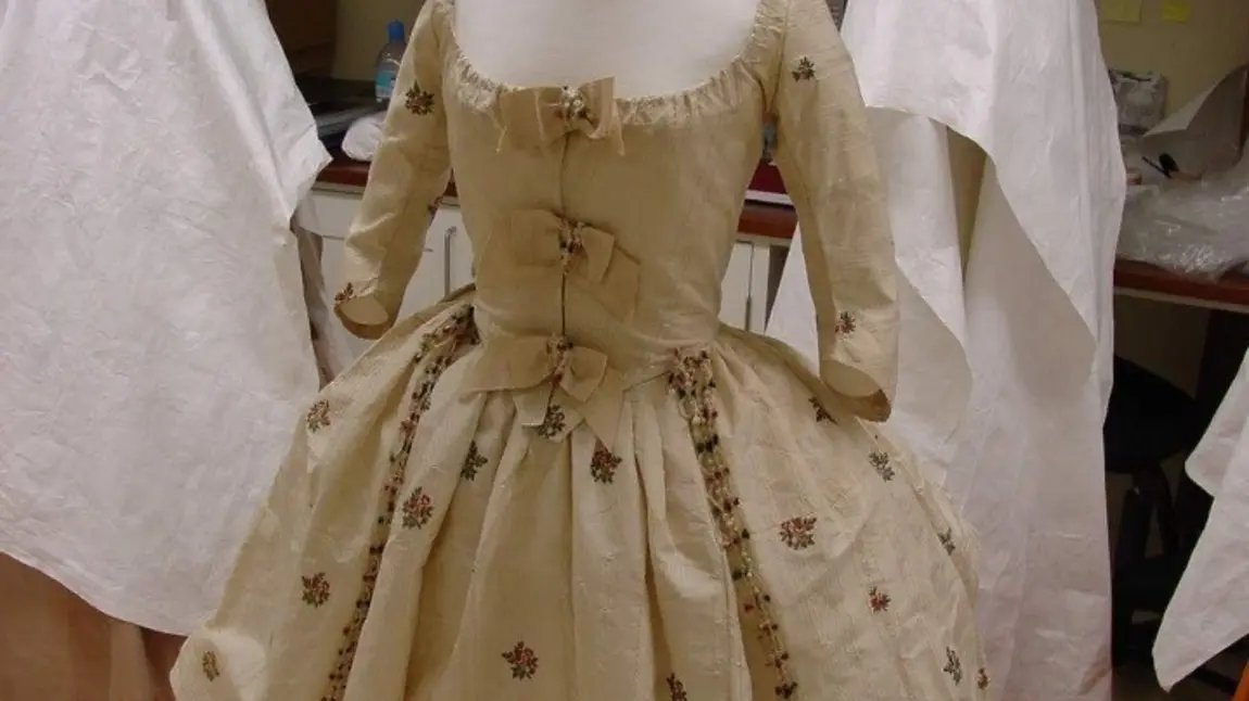 A crinoline-style skirt and matching bodice, in white cotton gauze with extensive beetle wing embroidery 