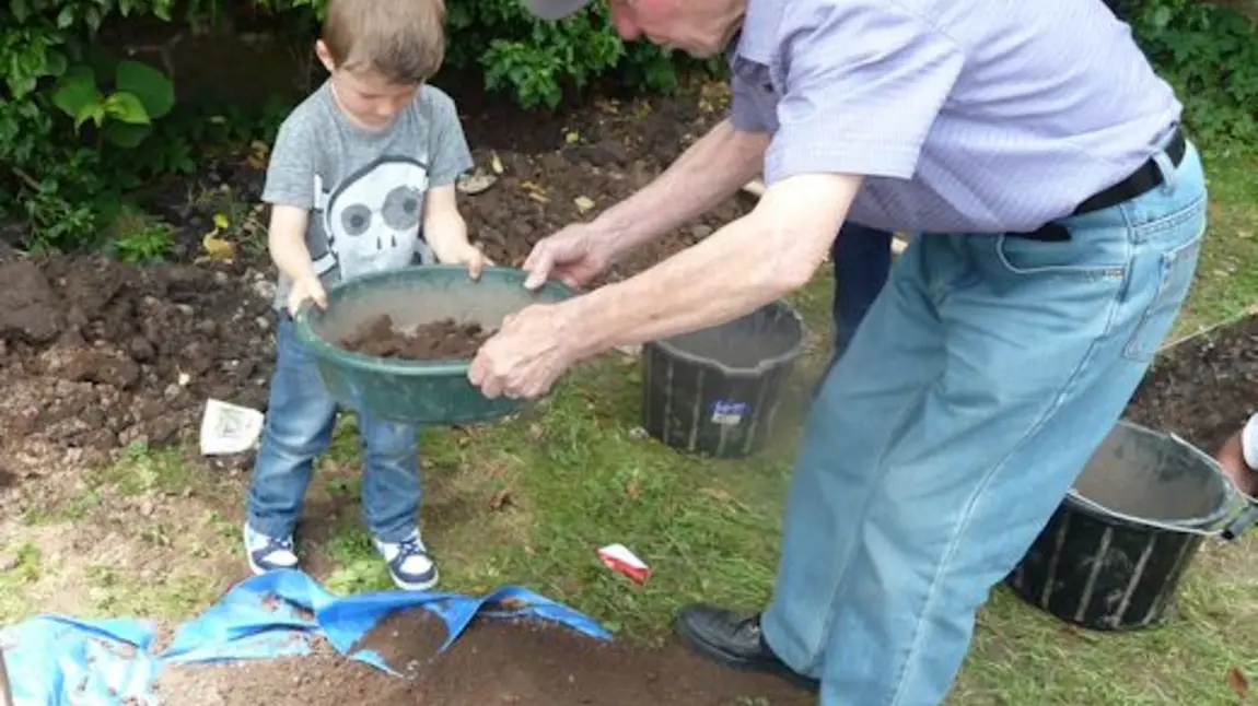 A child being shown the basics of archaeology