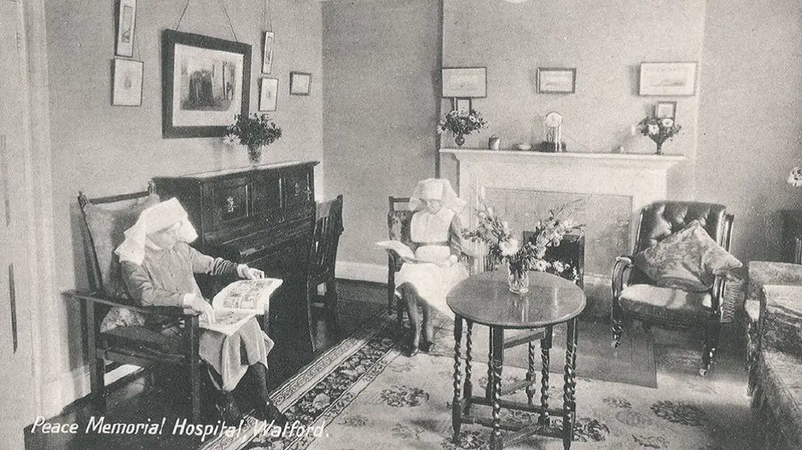 Archive image of nurses relaxing and reading in a sitting room at the Peace Hospice