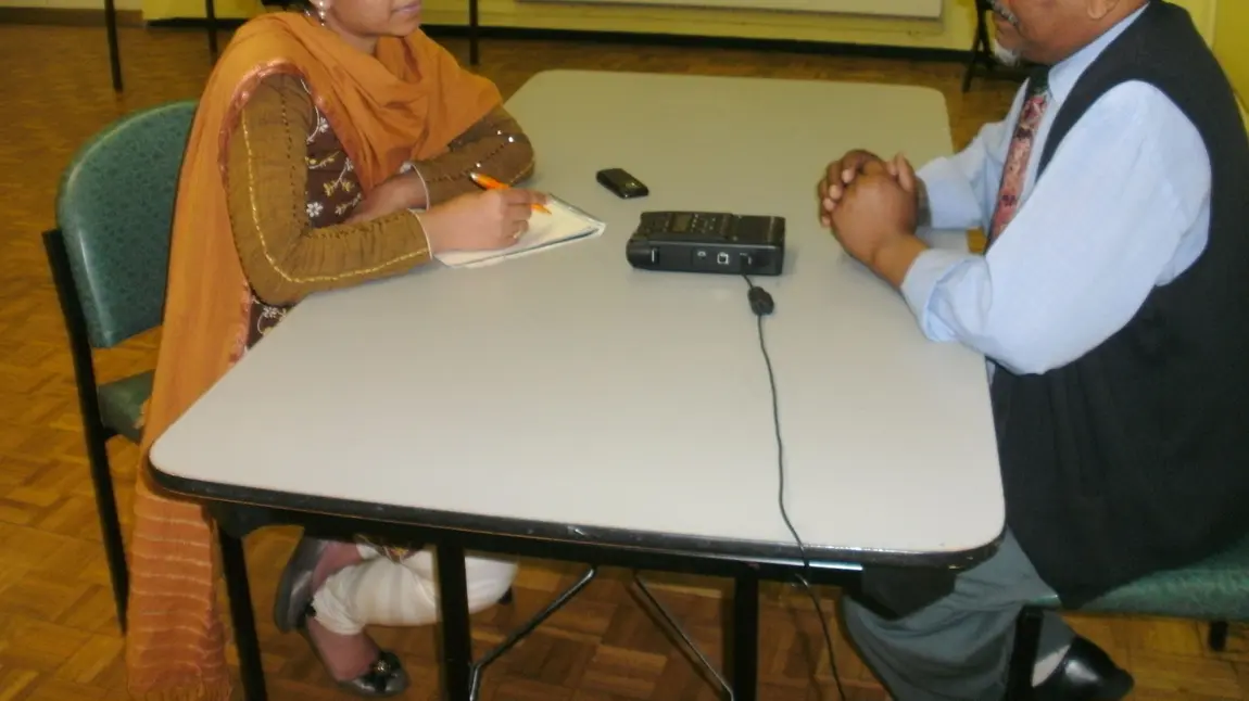 Adult volunteers conduct oral history interviews