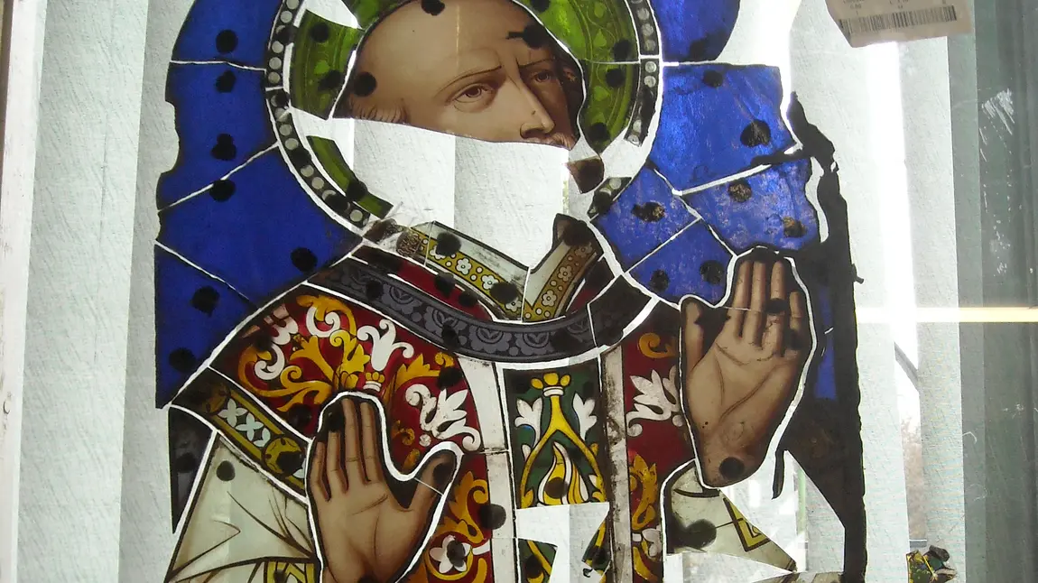Broken pieces of stained glass window depicting St Ignatius Loyola 