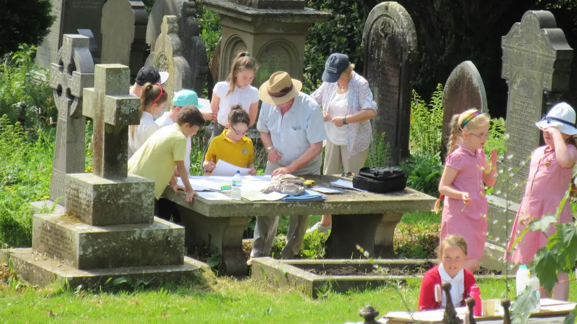 Workshop where children are doing rubbings on grave stones