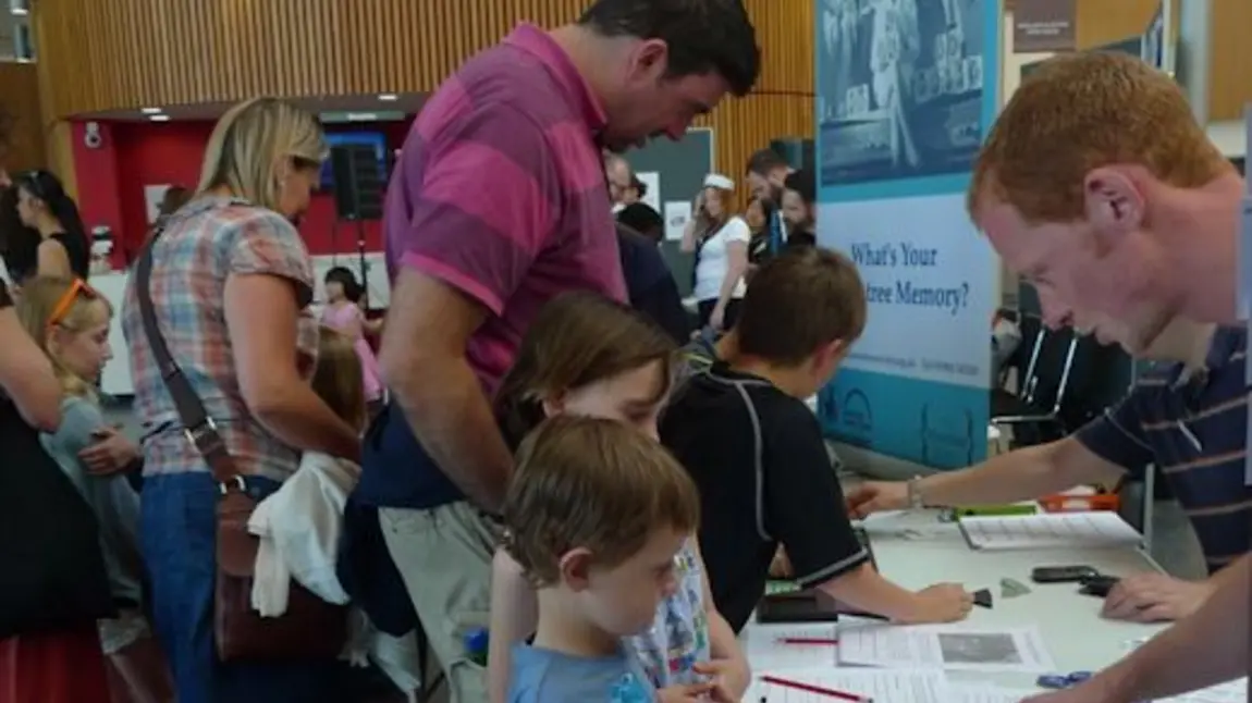 People visiting a Rowntree Society pop-up exhibition