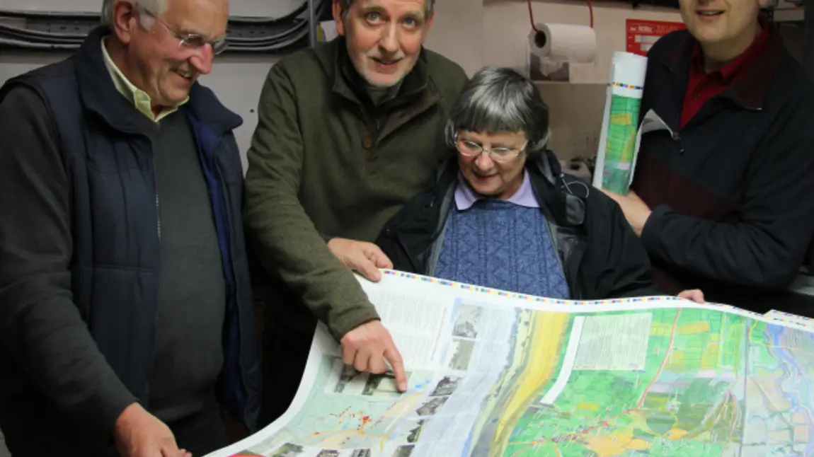 Volunteers from the Hadleigh and Thundersley Community Archive Group examine a walking map