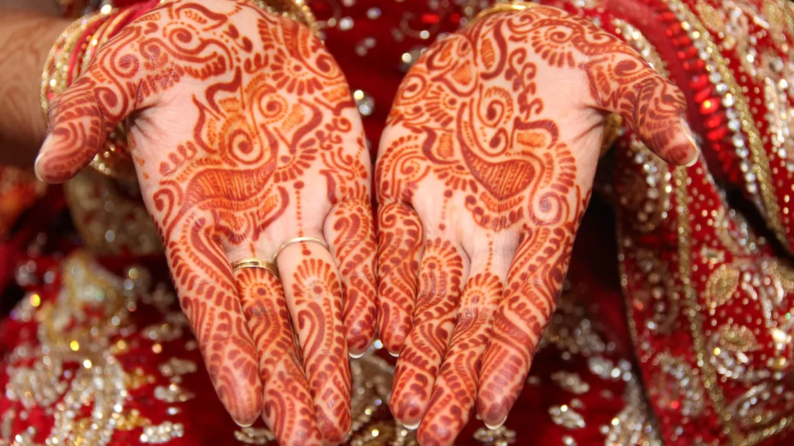 Picture of hands decorated in henna for a traditional South Asian wedding ceremony