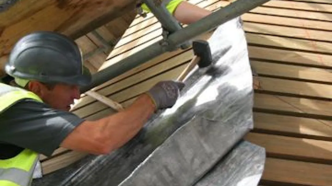 A man repairs the roof at Canterbury Cathedral