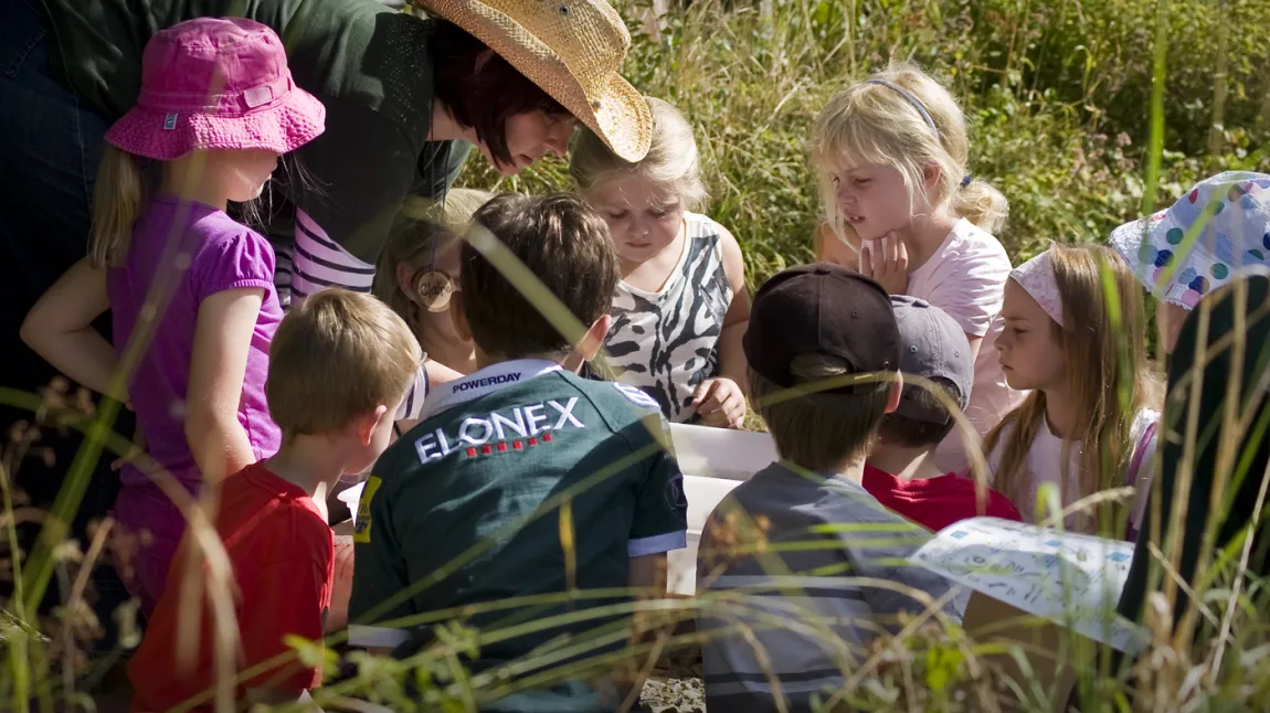Young visitors explore with Claire Garrity, College Lake's environmental education manager 