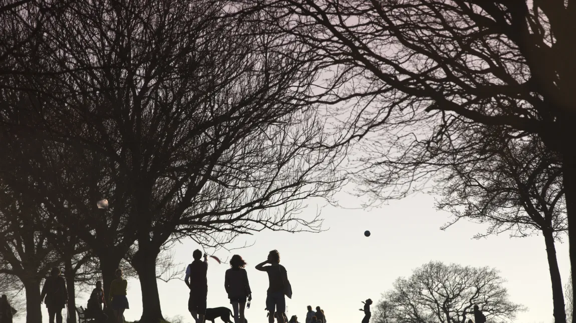 People walk dogs in Brockwell Park, South London