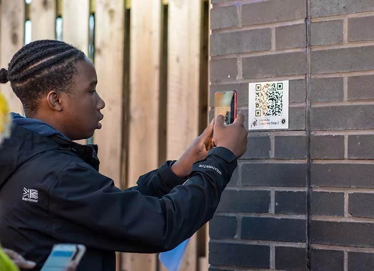 Young man scanning a QR code