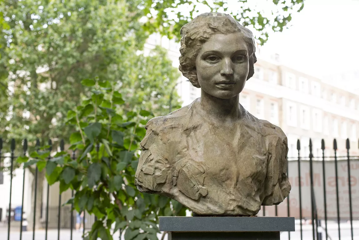 Bronze sculpture showing the head and shoulders of a woman