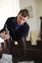 Person touching wooden furniture 